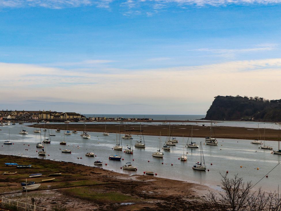 A water view with boats and land at Orchard Cottage in Dawlish