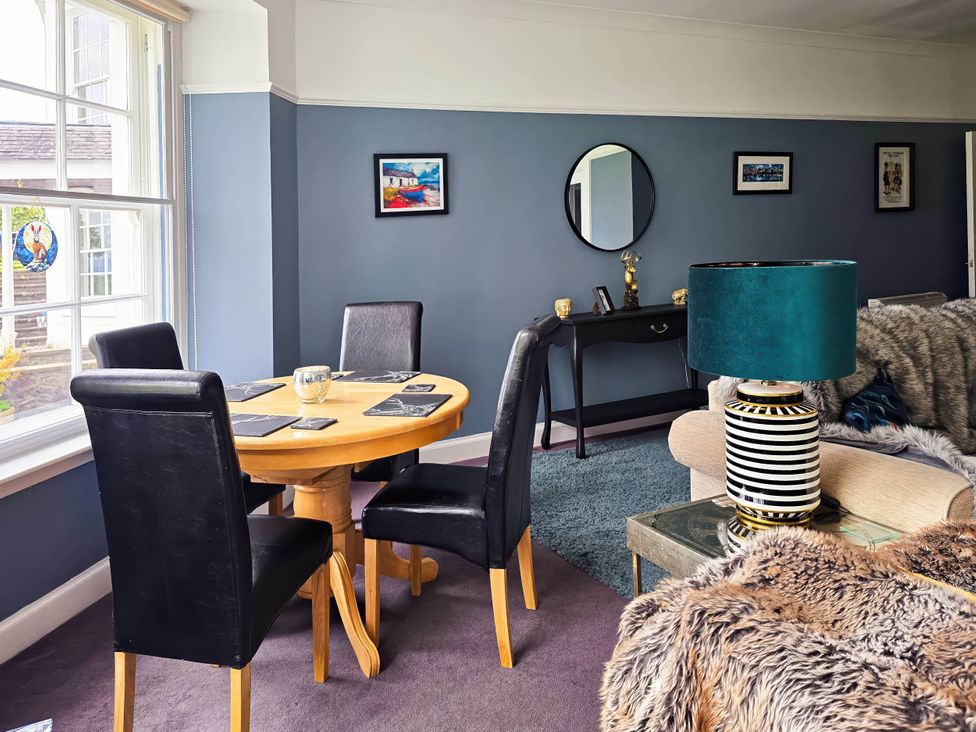 A dining room with a round table and chairs at The Old Barn in Manchester