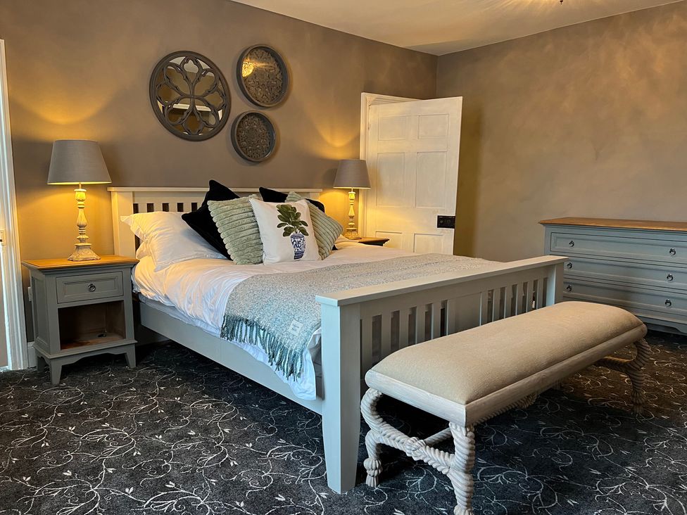 A bedroom with a bed and nightstand at ASH HOUSE in Wincanton