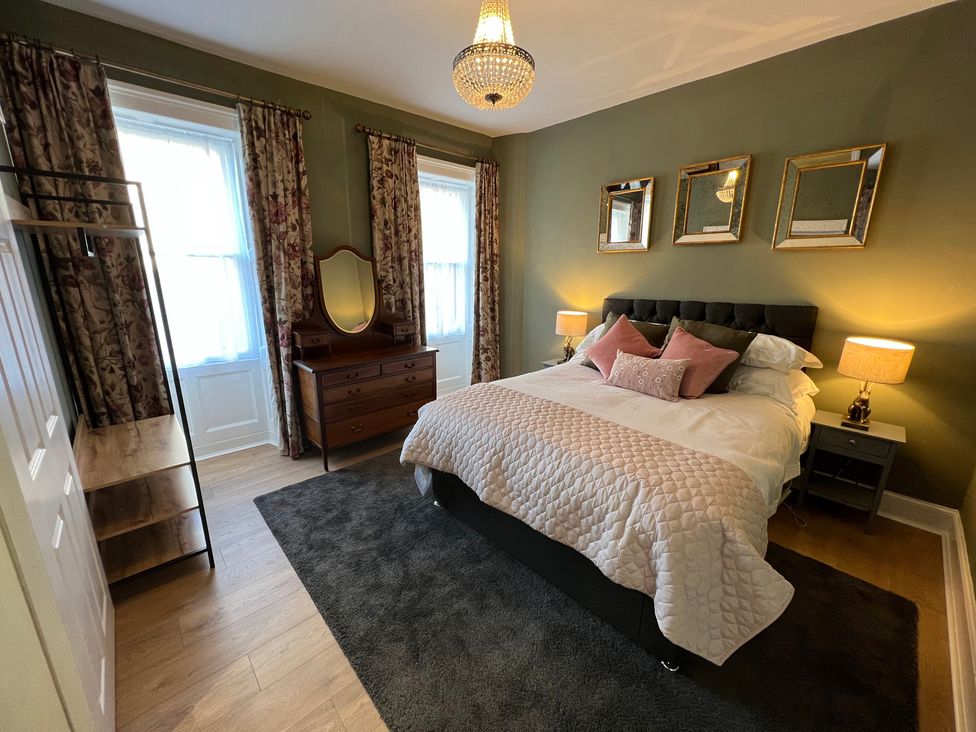 A bedroom with a bed and dresser at ASH HOUSE in Wincanton