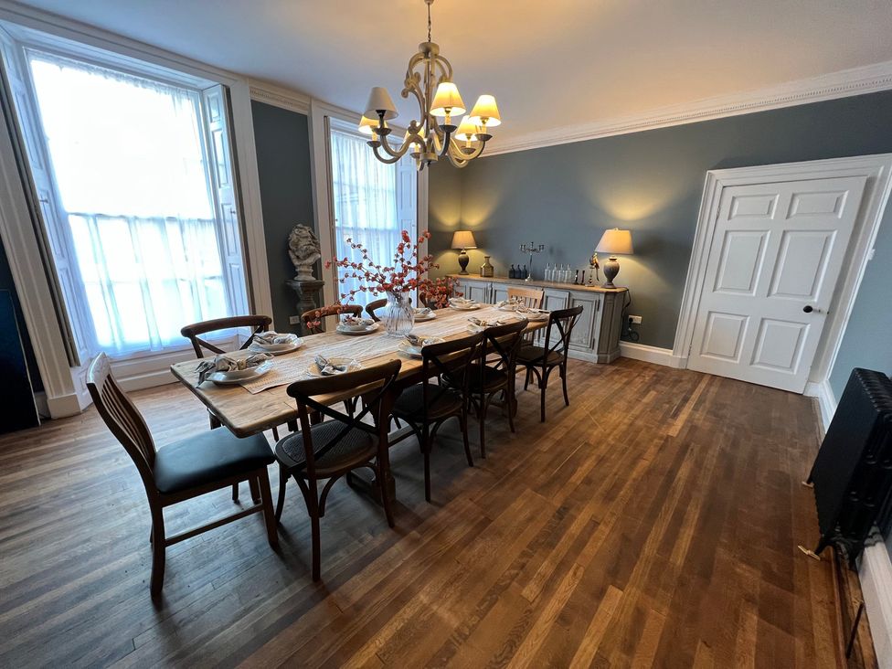 A dining room with a large table and chairs at ASH HOUSE in Wincanton