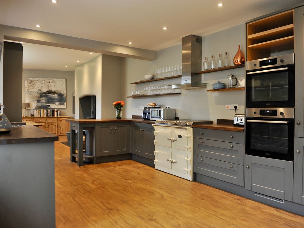 A kitchen with cabinets and appliances at ASH HOUSE Wincanton