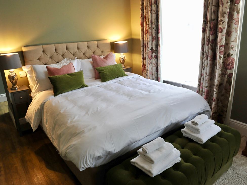 A bedroom with a bed and nightstand at ASH HOUSE in Wincanton