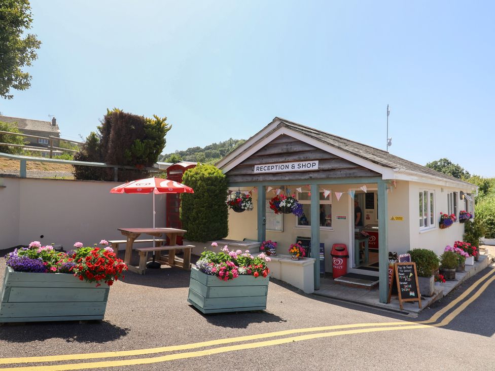 An outdoor reception and shop area with flowers at caravan NEW Uplyme