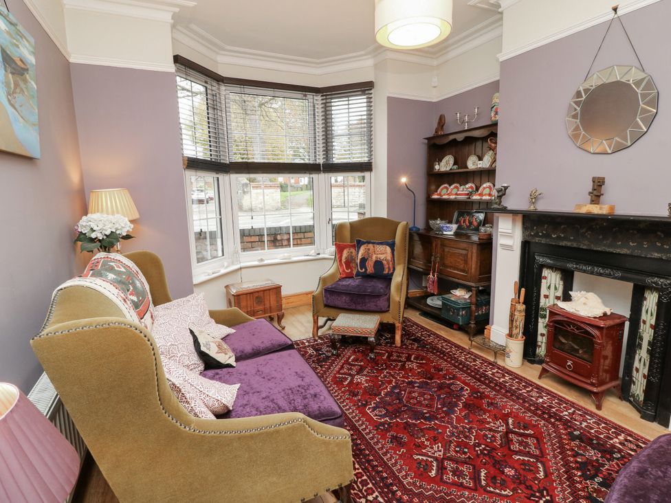 A living room with a sofa and fireplace at Norbury House in Lincoln