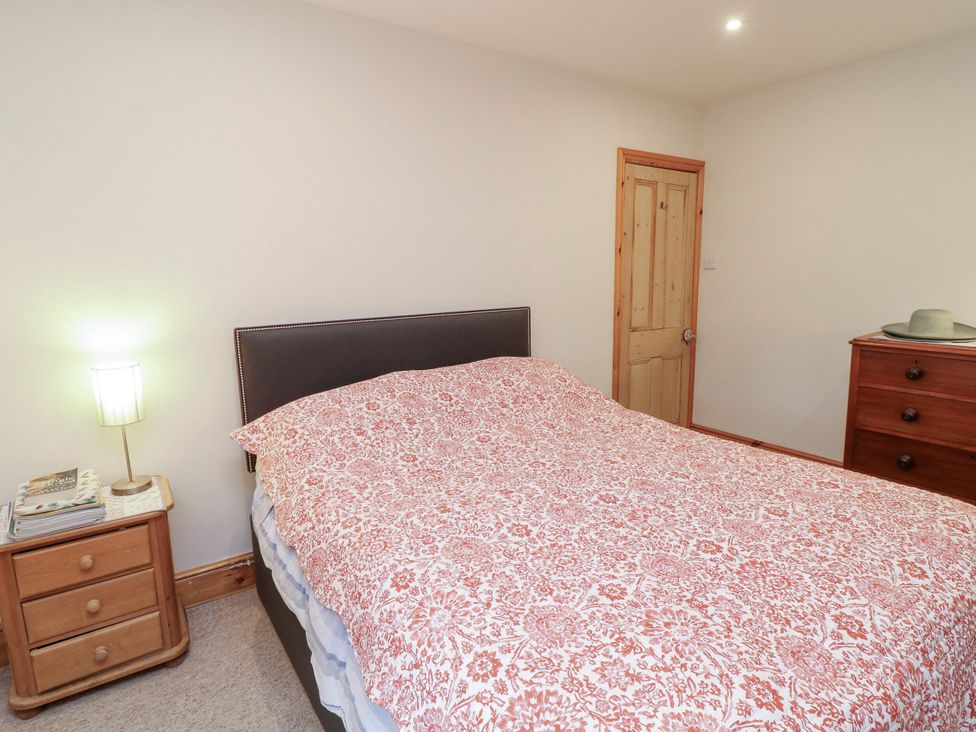 A bedroom with a bed and nightstand at Norbury House in Lincoln