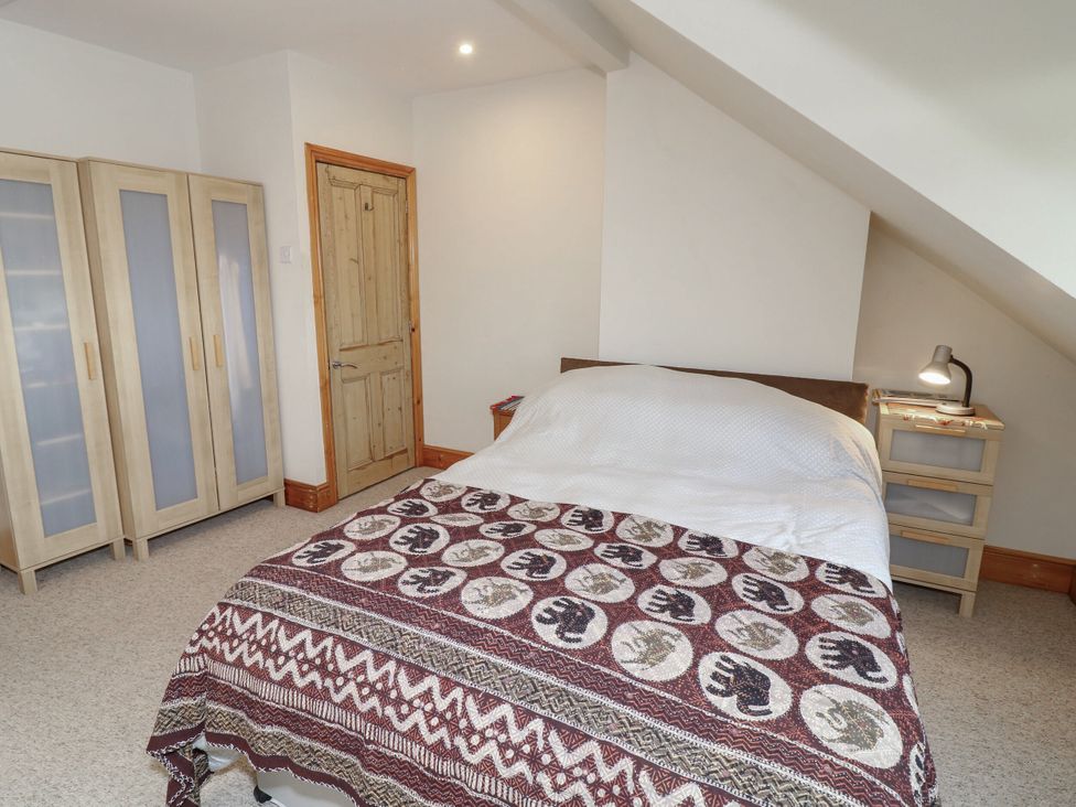 A bedroom with a bed and wardrobe at Norbury House in Lincoln