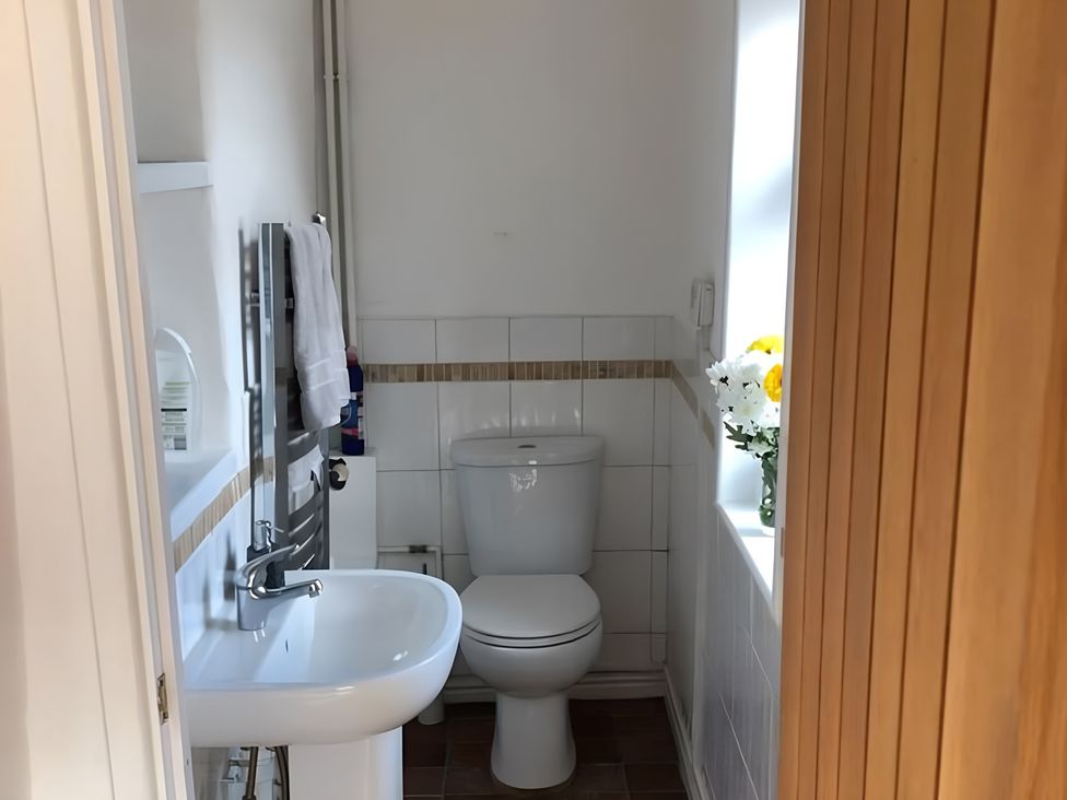 A bathroom with a toilet and sink at Tranquil Cottage