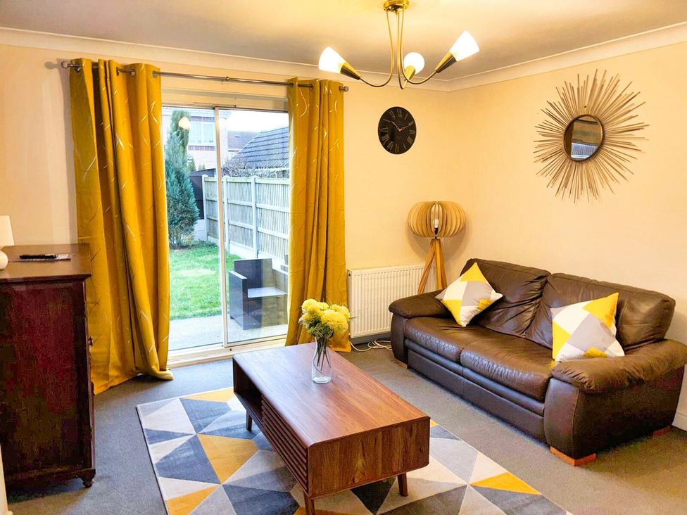 A living room with a sofa and coffee table at 22 Homestead Garth