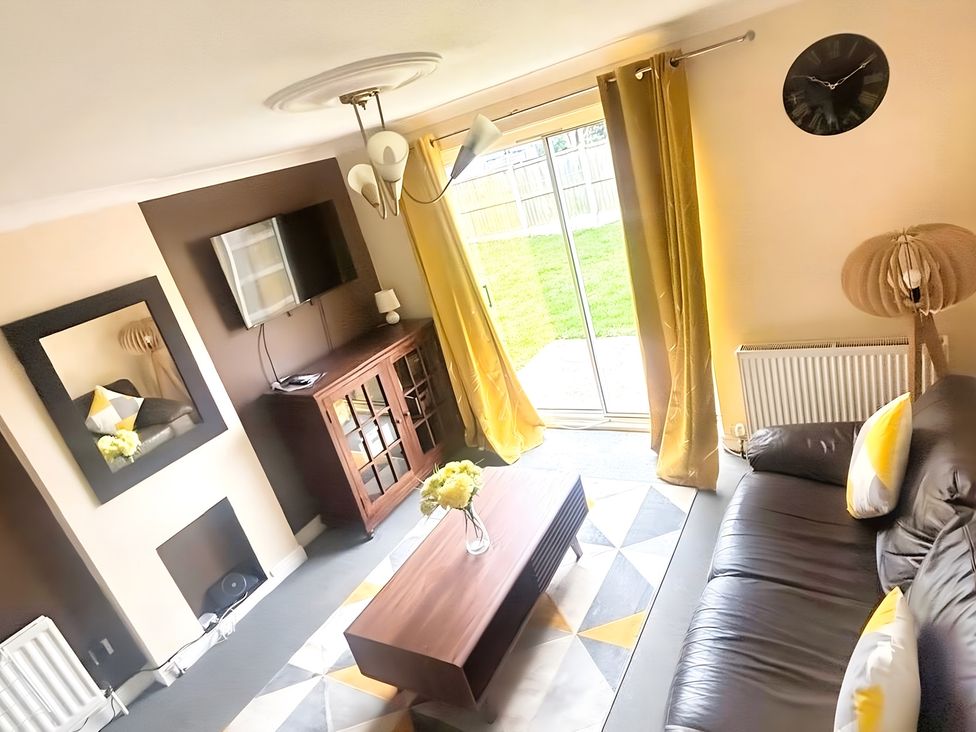 A living room with a sofa and coffee table at 22 Homestead Garth