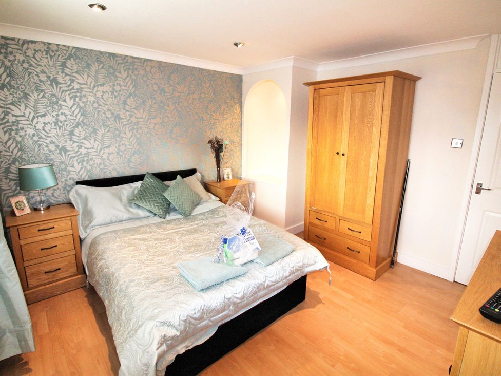 A bedroom with a bed and nightstand at 22 Homestead Garth