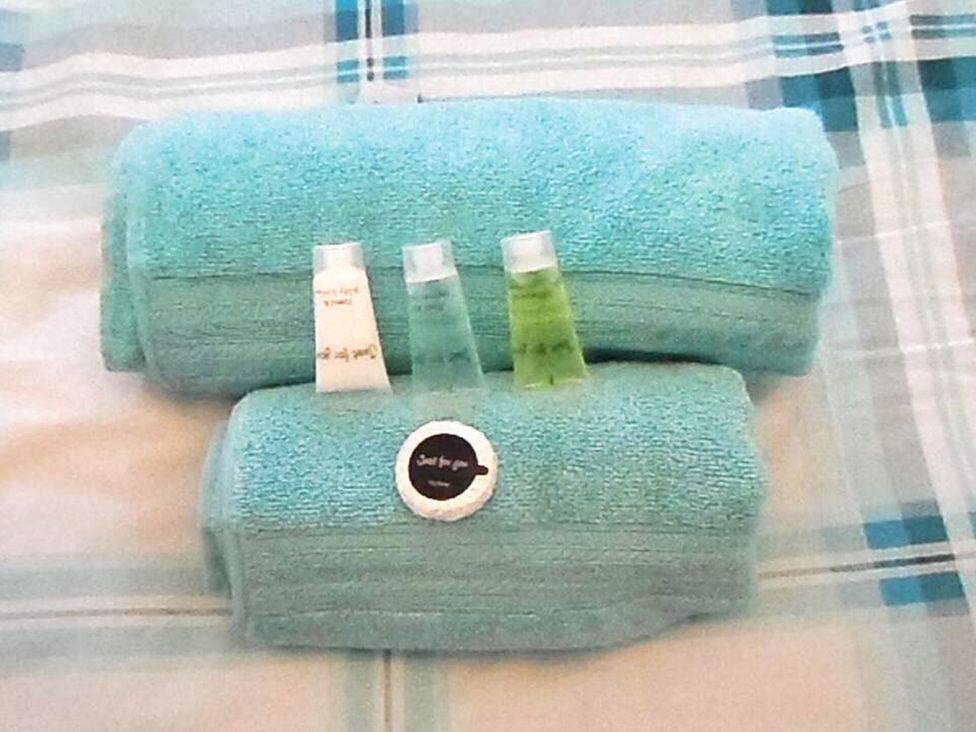 Towels and toiletries on a bed at 22 Homestead Garth