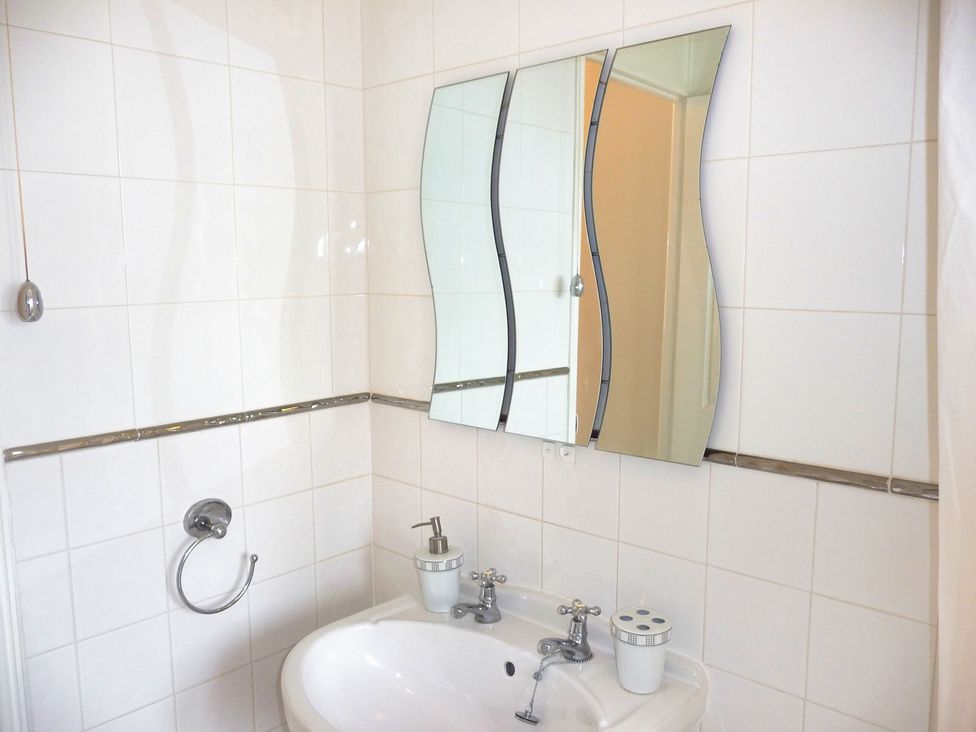 A bathroom with a sink and mirror at 22 Homestead Garth