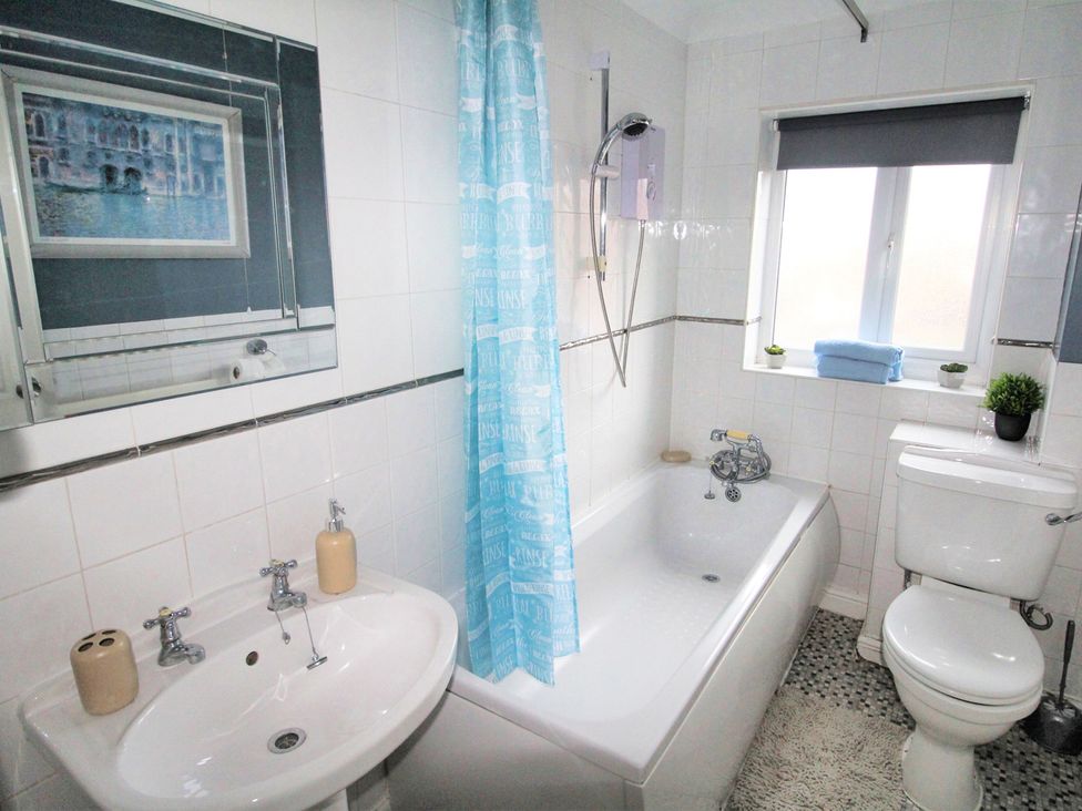 A bathroom with a bathtub, sink, toilet and shower at 22 Homestead Garth in 
