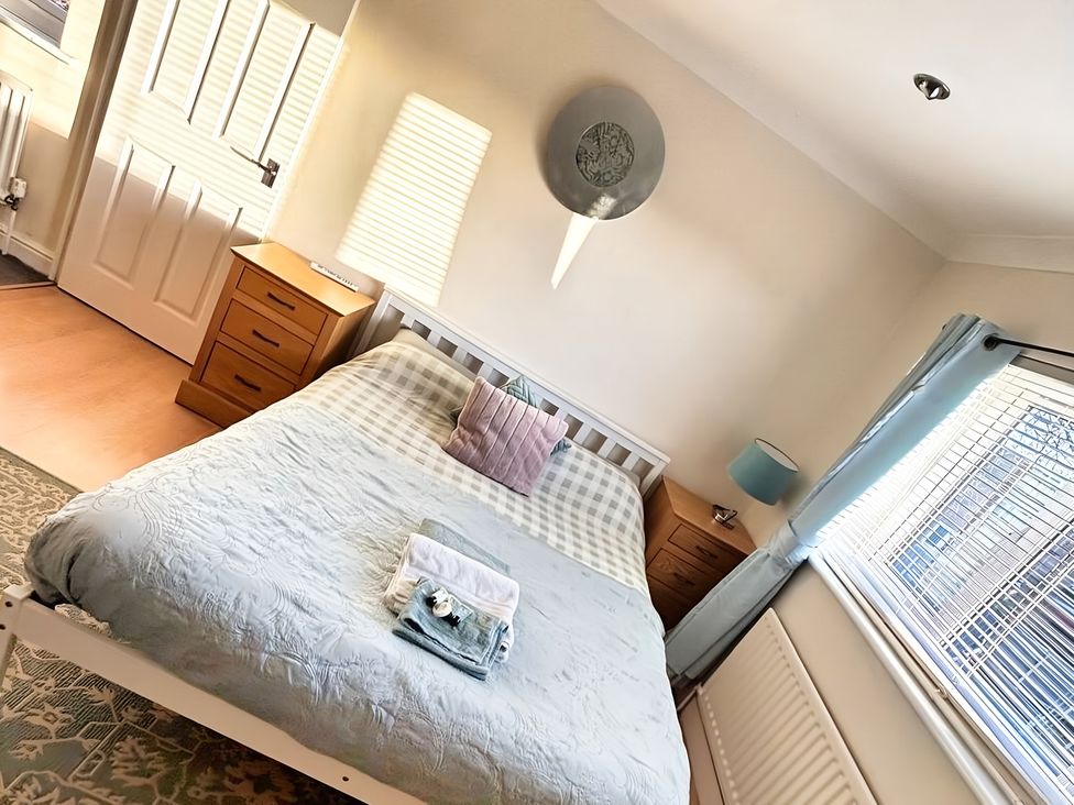 A bedroom with a bed and dresser at 22 Homestead Garth