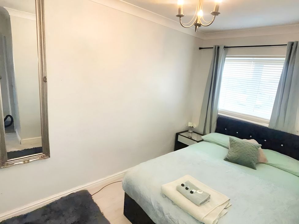 A bedroom with a bed and nightstand at 22 Homestead Garth