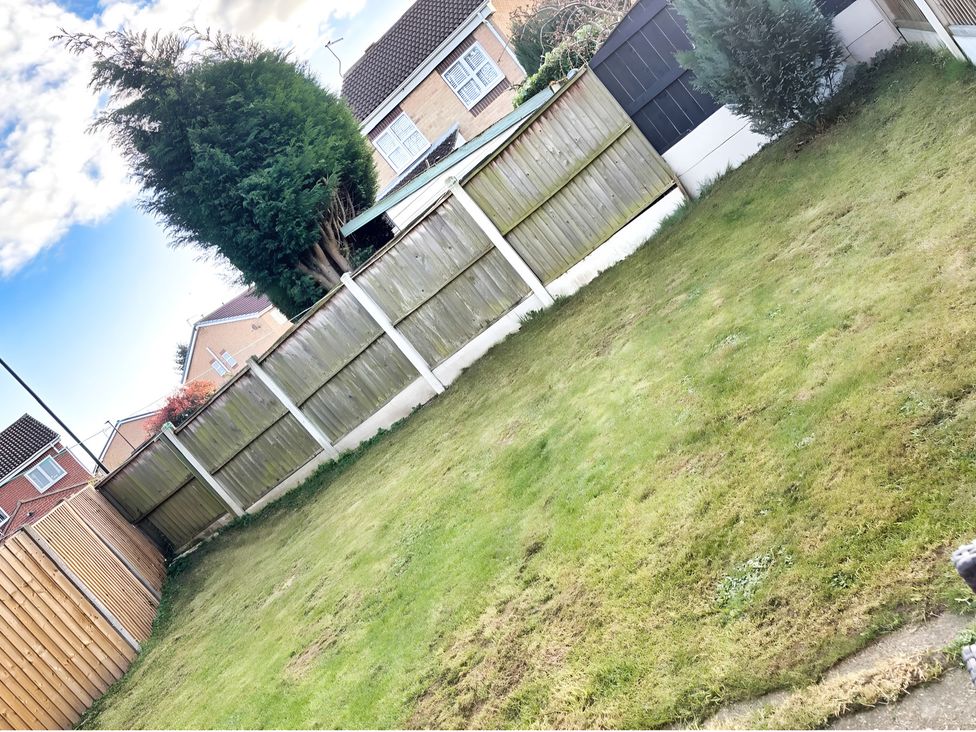 A garden with grass and fences at 22 Homestead Garth