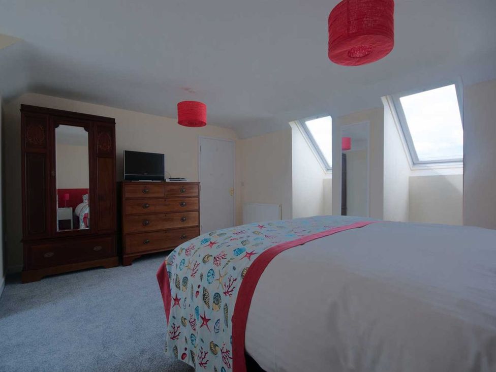 A bedroom with a bed and television at Chynoweth in Crantock