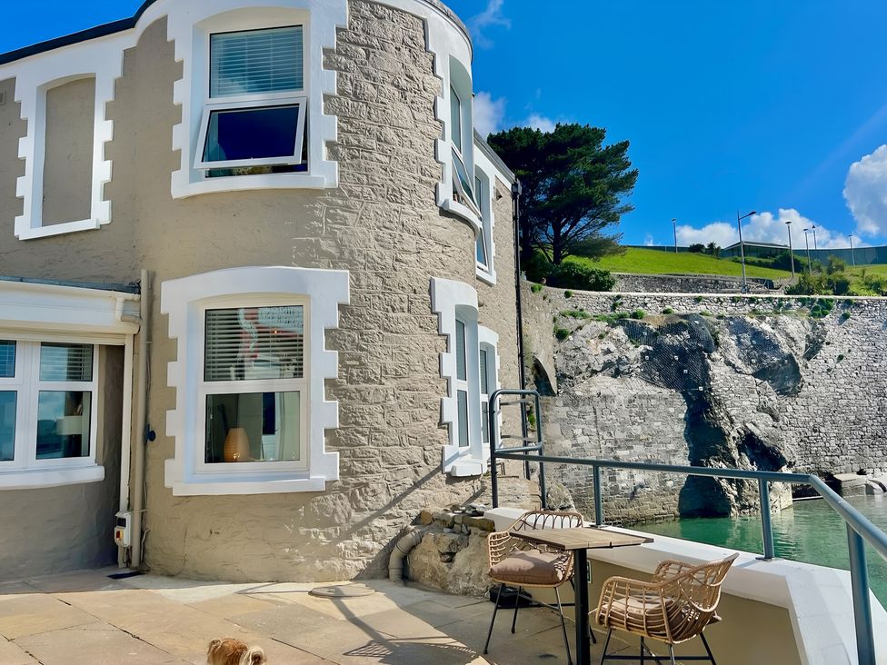 An outdoor area with seating and a view at Seafront Cottage