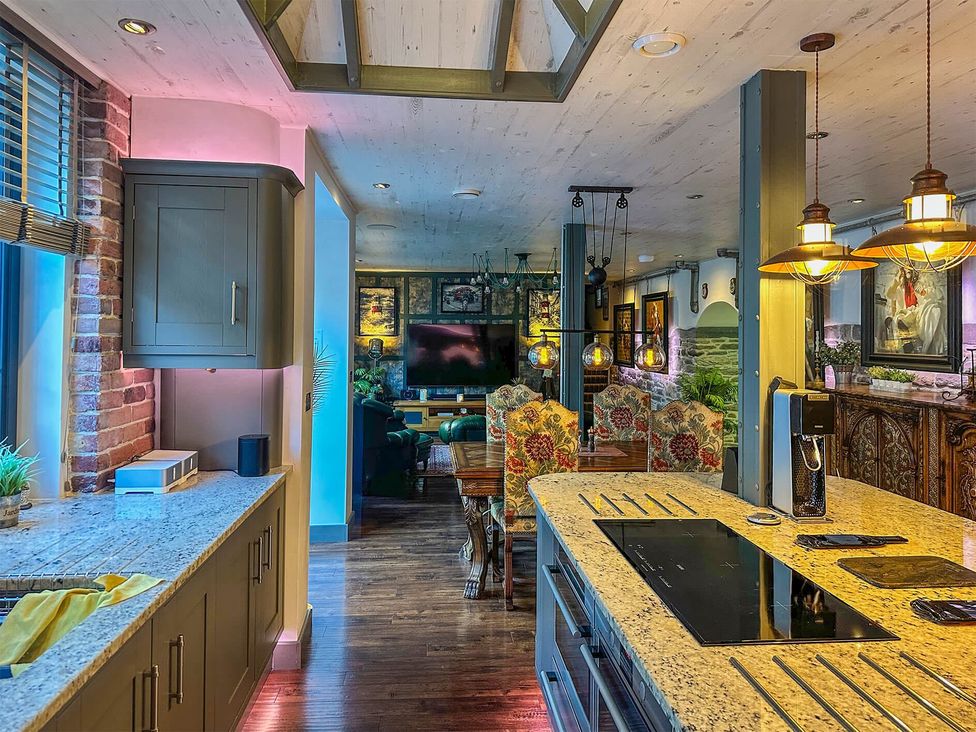 A kitchen with a stove and dining area at the property