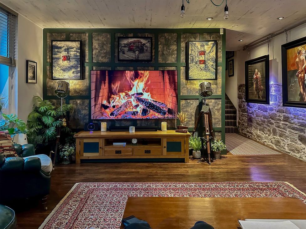 A living room with a fireplace and television at 
