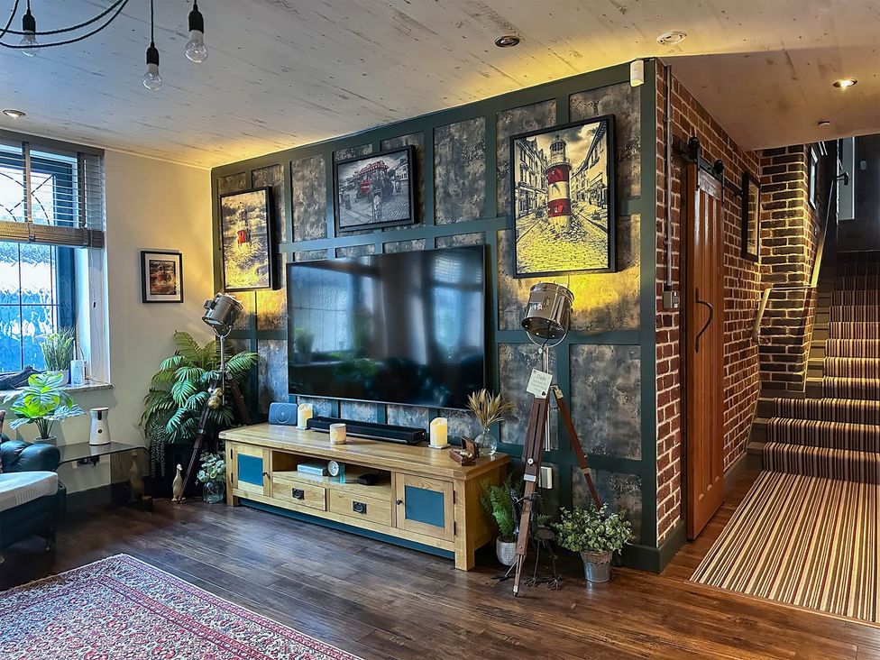 A living room with a television and plants at the property