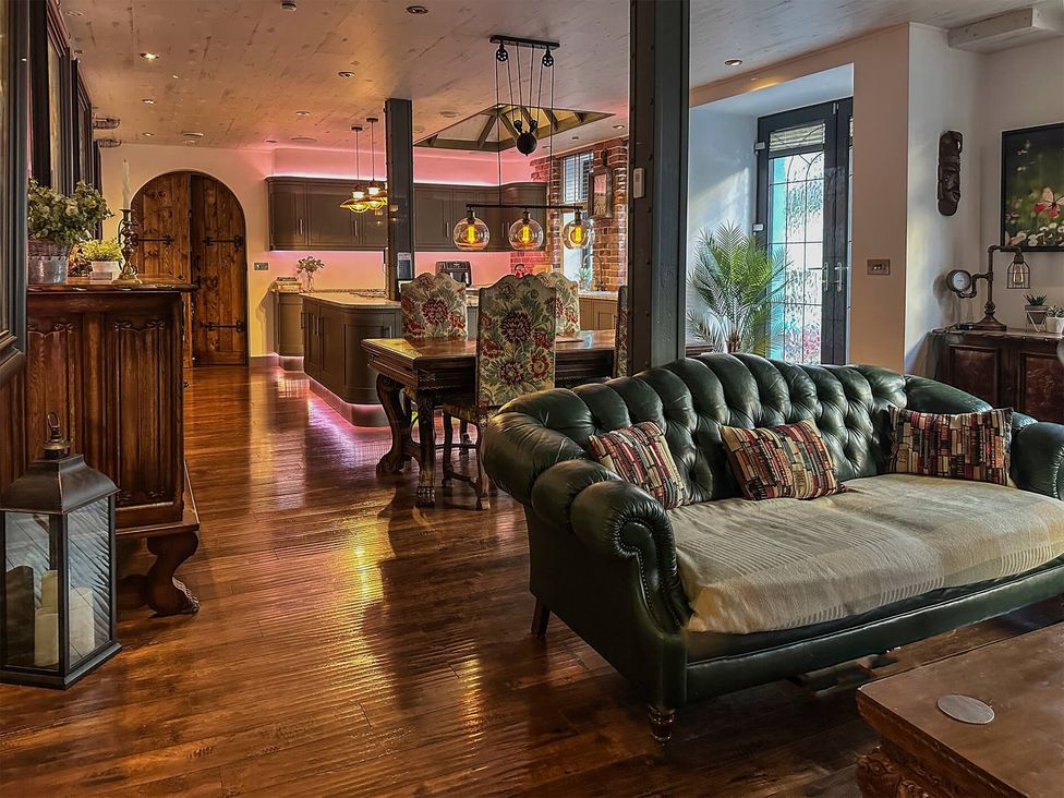 A living room with a sofa and wooden table at The Old Barn in Manchester