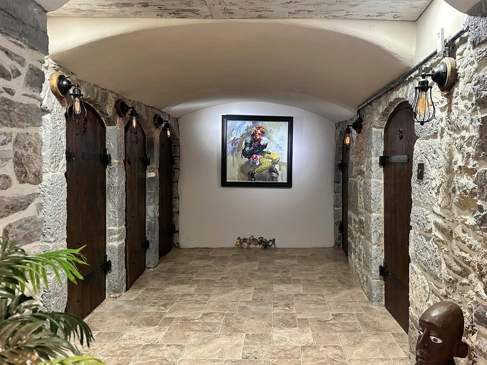 A hallway with stone walls and wooden doors at 