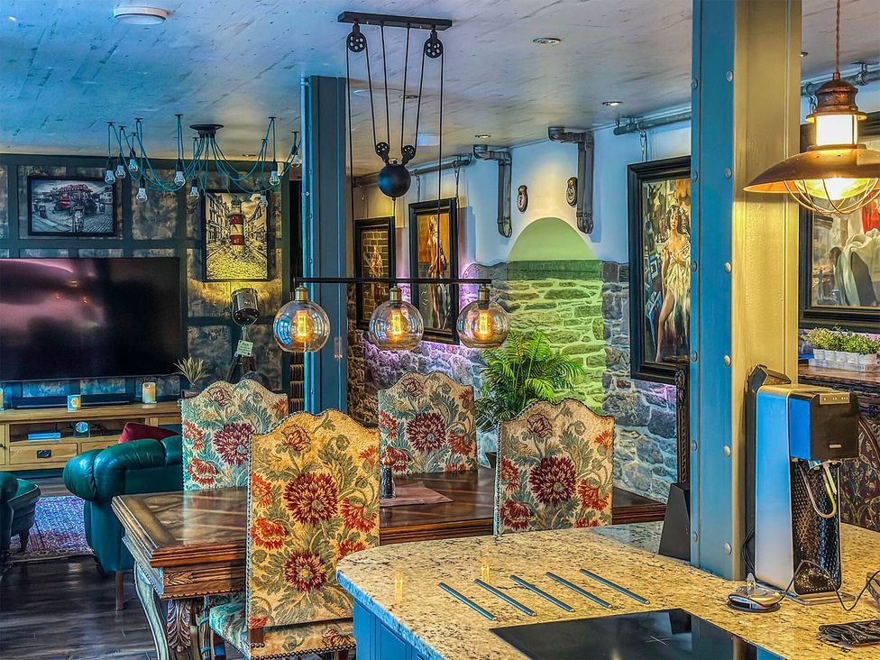 A dining room with a table and chairs at a property 