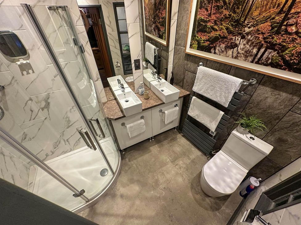 A bathroom with shower, sinks, and toilet at the property