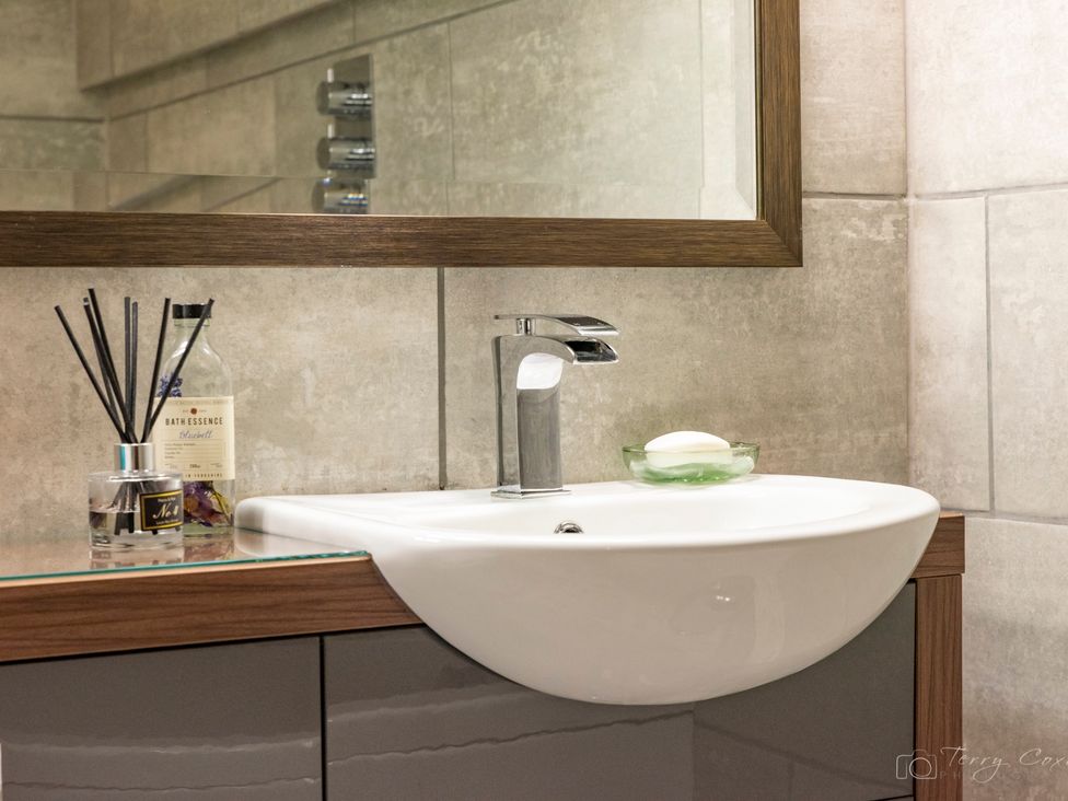 A sink with a faucet and soap in a bathroom