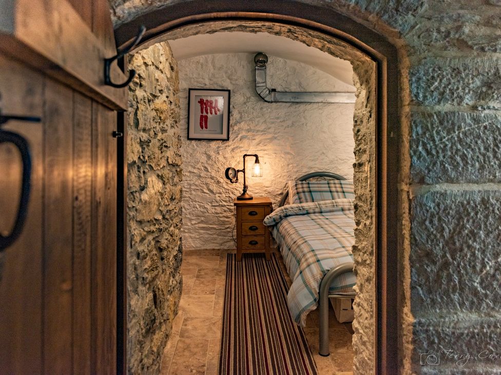 A bedroom with a bed and a nightstand at 