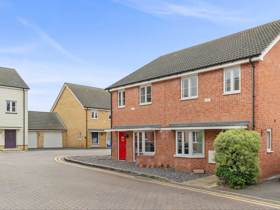 A house with a red door and windows at a residential area