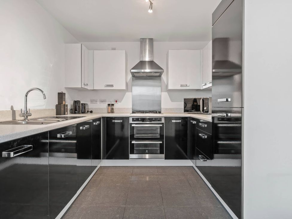 A kitchen with cabinets and appliances at the property