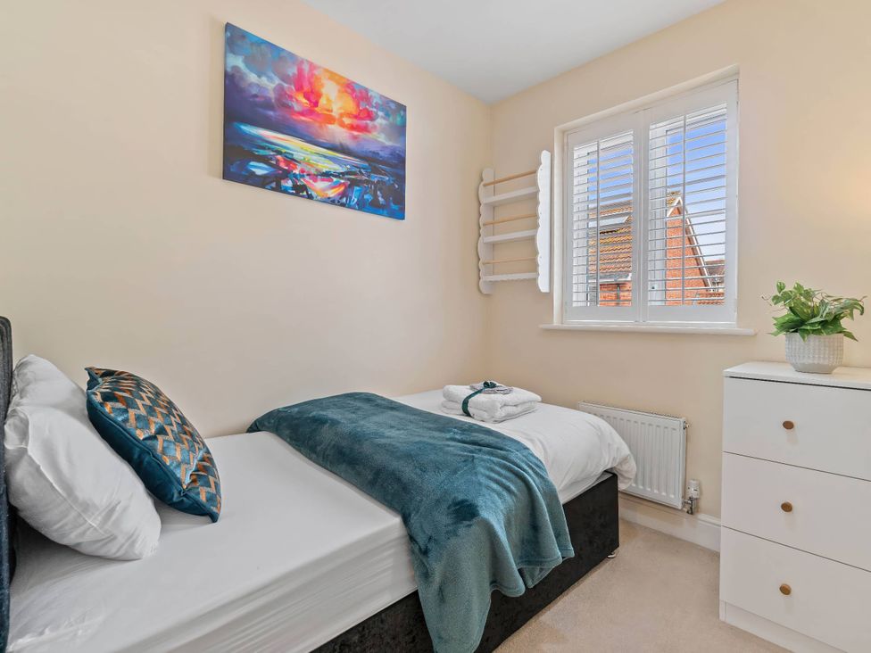 A bedroom with two beds and a dresser at The Old Barn in Manchester