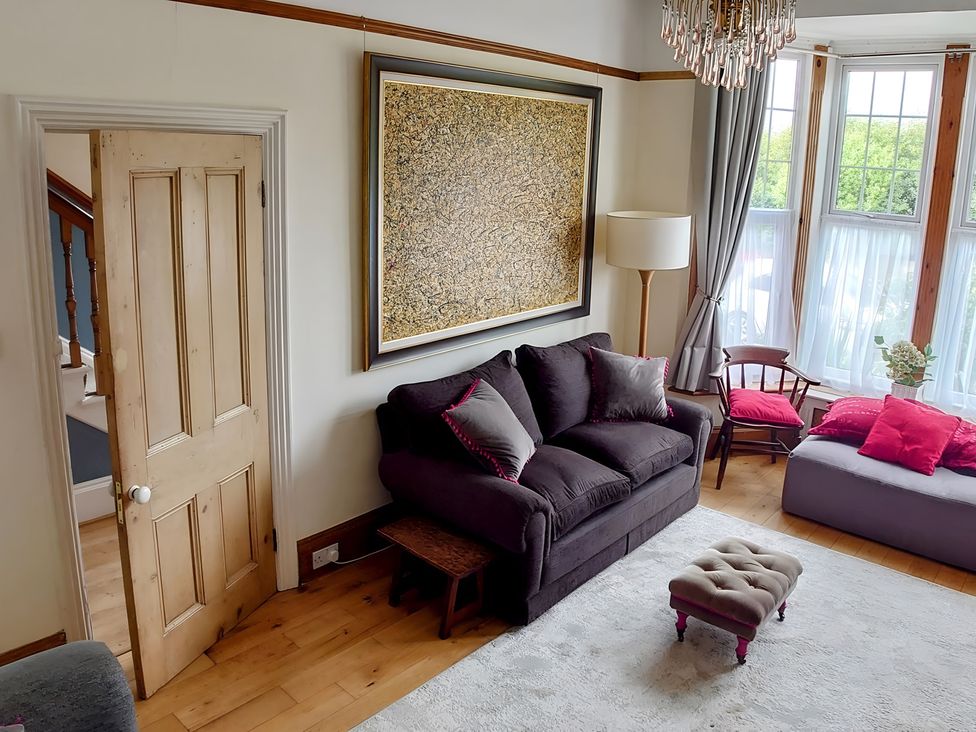 A living room with a sofa and door at 55 Egerton Road 