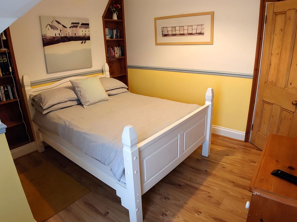 A bedroom with a bed and bookshelf at 55 Egerton Road