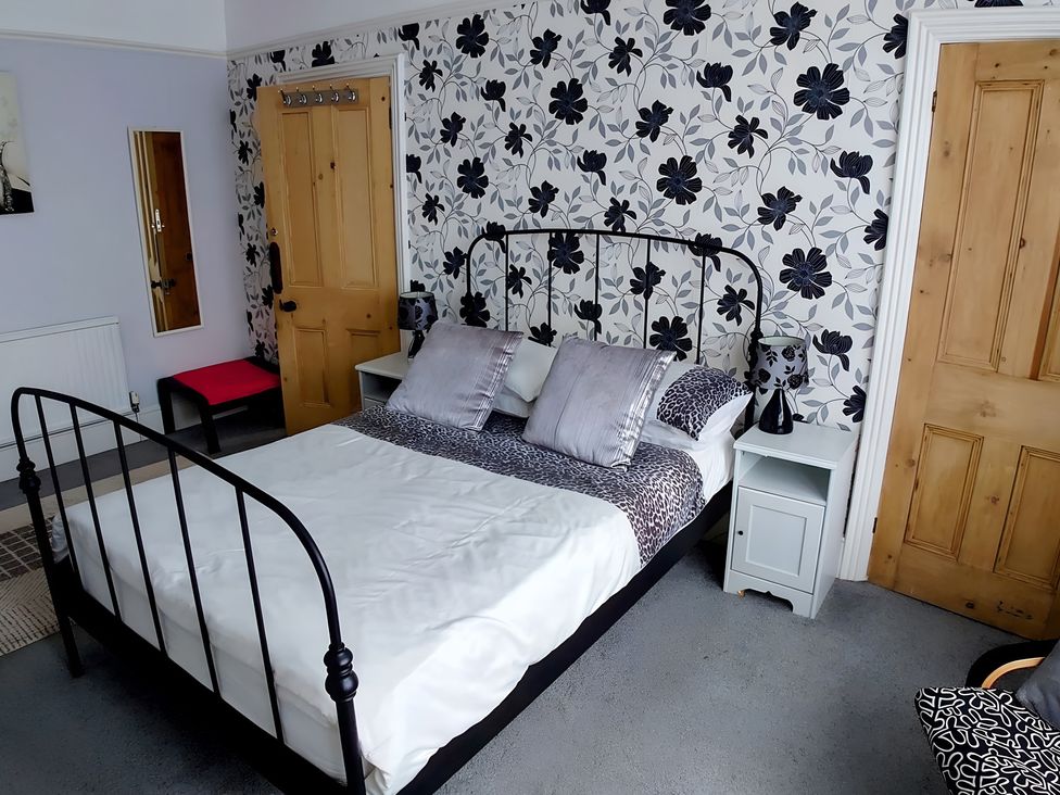 A bedroom with a bed and bedside table at 55 Egerton Road