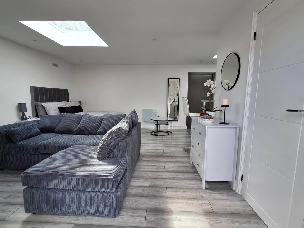 A living room with a sofa and a table at The Old Barn in Manchester