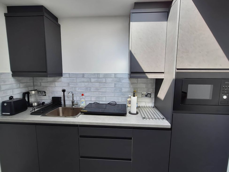 A kitchen with cabinets, sink, and appliances at the property location