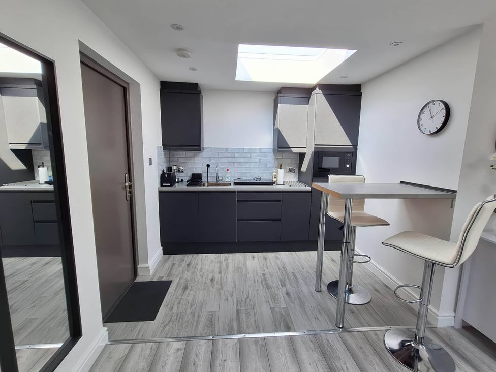 A kitchen with a fridge and microwave at the property in the location