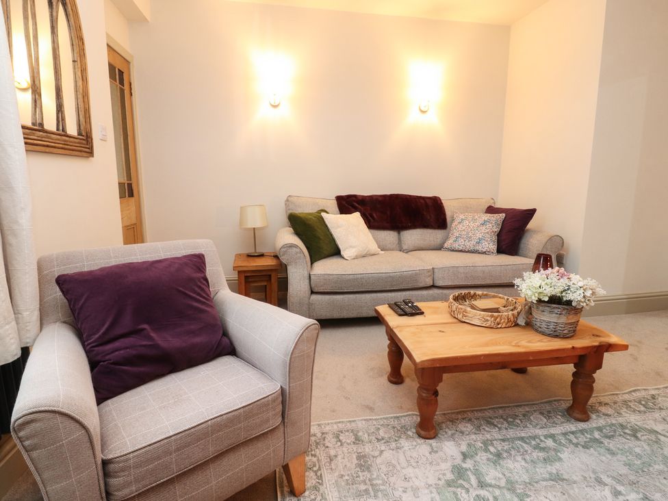 A living room with a sofa and armchair at Levenside Preston