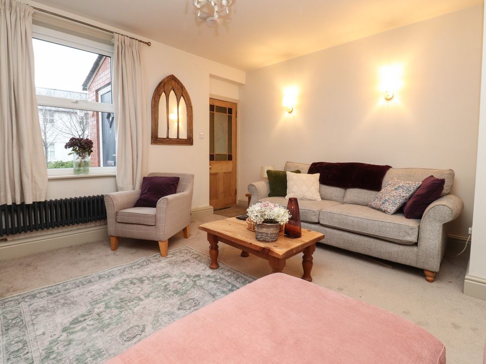 A living room with a sofa and armchair at Levenside Preston