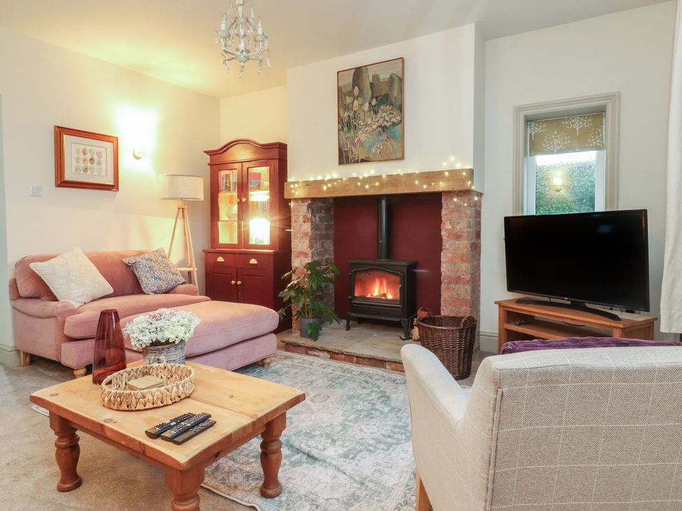 A living room with a sofa and television at Levenside in Preston