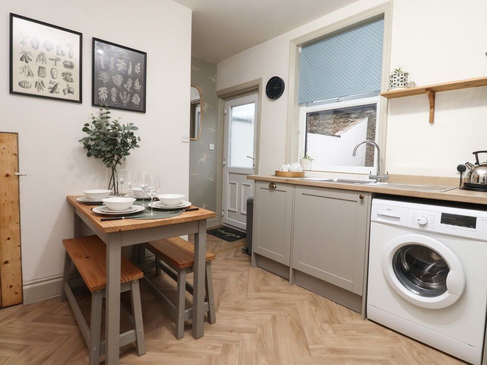 A kitchen with table and chairs at Levenside in Preston