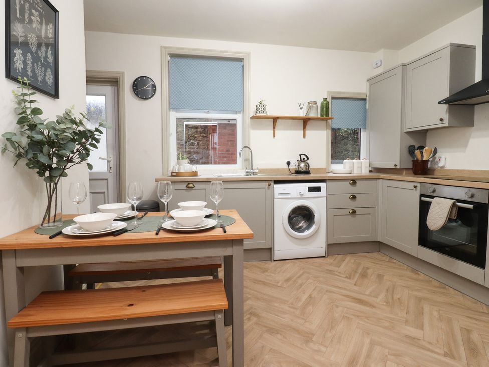 A kitchen with a table set for dining at Levenside in Preston