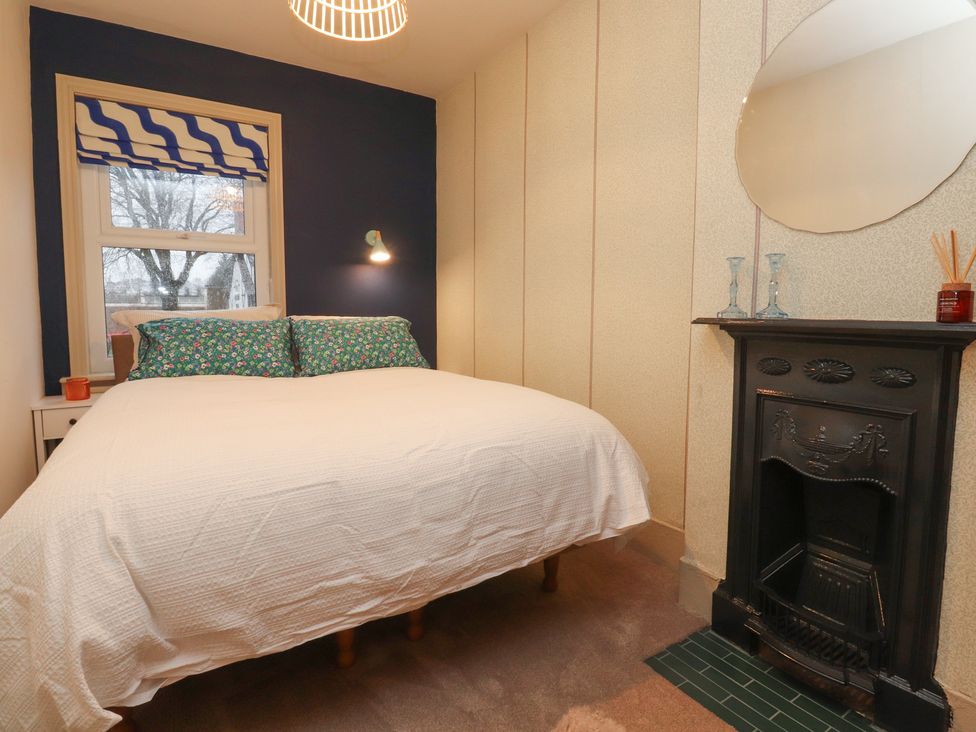 A bedroom with a bed and window at Levenside Preston