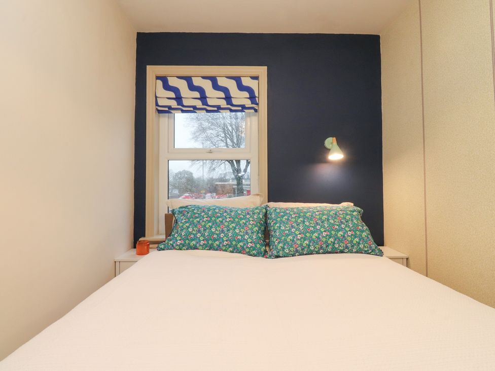 A bedroom with a bed and window at Levenside in Preston