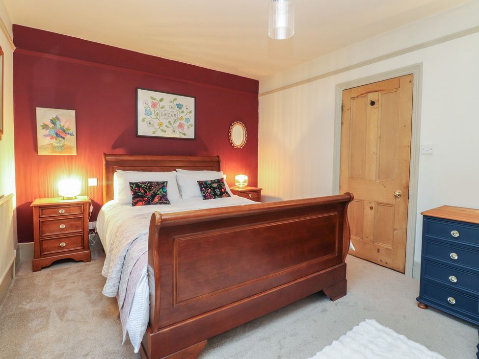 A bedroom with a bed and nightstand at Levenside in Preston