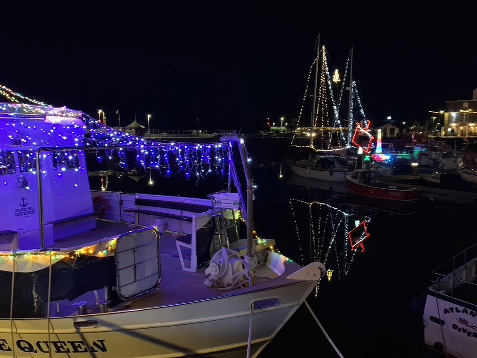 A boat with lights at a harbor at The Granary, Engollan near St Merryn